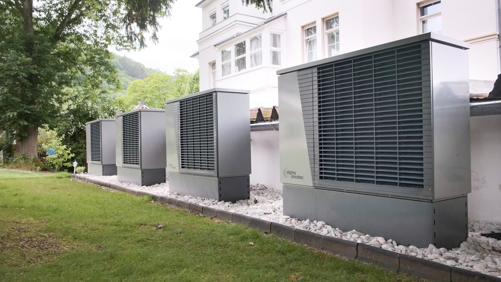 Outdoor heat pump unit installed beside a home