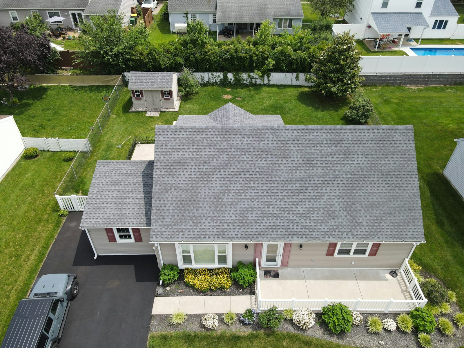 Roofers laying asphalt shingles on a residential roof