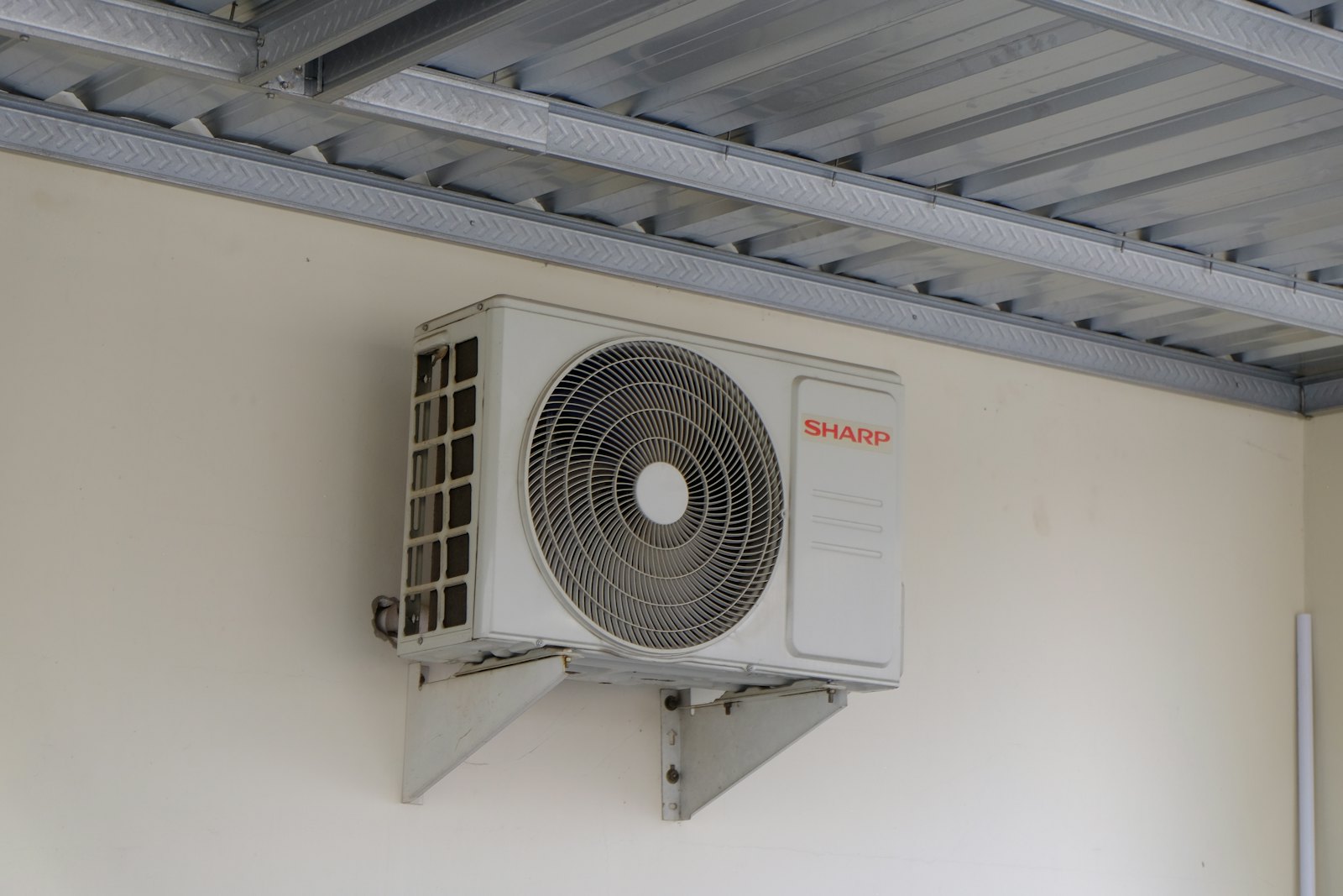 Outdoor HVAC condenser unit installed beside a residential home